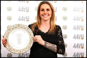 Kelly Smith with an award